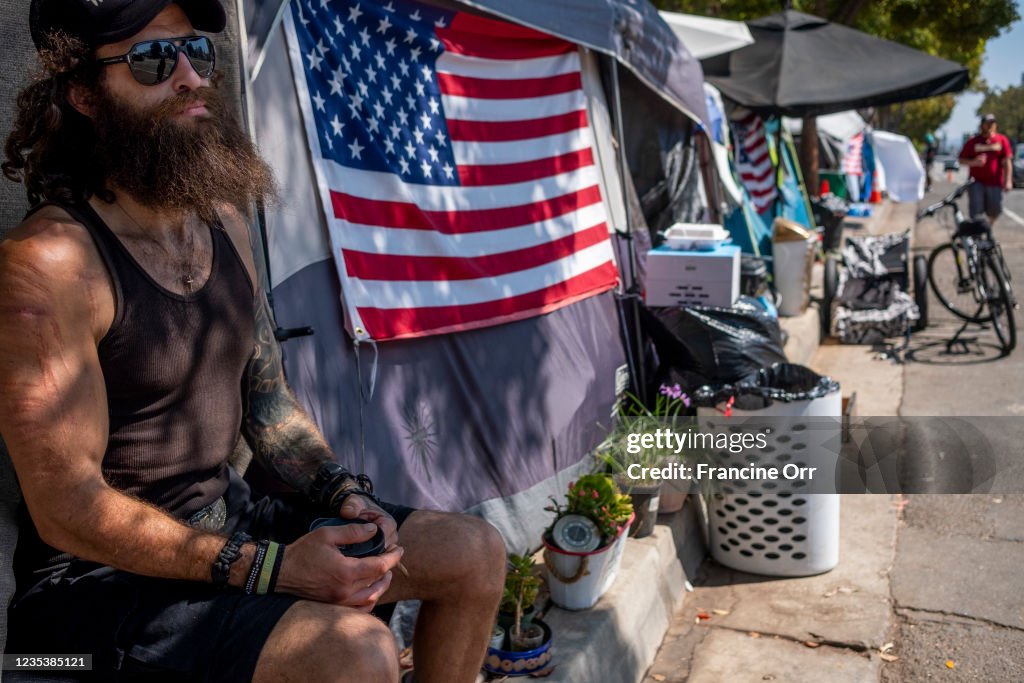 Homeless encampment outside the West L.A. Veterans Affairs facilities. Dozens of veterans live at the encampment, sometimes called Veterans Row, where some tents are decorated with U.S. flags.