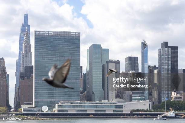 Birds fly past the United Nations headquarters in New York, U.S., on Monday, Sept. 20, 2021. A scaled-back UN General Assembly is returning to...