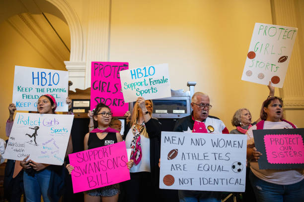 Demonstrators supporting restrictions on transgender student athletes are gathered at the Texas State Capitol on the first day of the 87th...