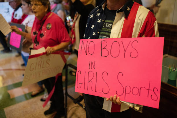 Demonstrators supporting restrictions on transgender student athletes are gathered at the Texas State Capitol on the first day of the 87th...
