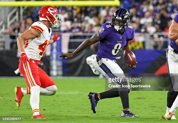 Baltimore Ravens quarterback Lamar Jackson scrambles out of the pocket and is pursued by Kansas City Chiefs defensive back Daniel Sorensen during the...