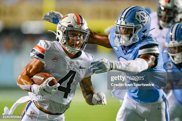 Virginia wide receiver Billy Kemp IV is tackled by North Carolina defensive back Don Chapman during the NCAA football game between the Virginia...