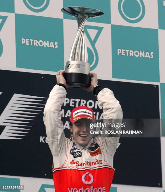 Spanish Formula One driver raises his trophy after winning the Malaysian Grand Prix, in Sepang International Circuit 08 April 2007. Defending world...