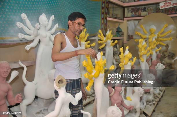 Artist Nondi Paul paints a sculpture of Goddess Durga Idols as part of preparation for the upcoming Hindu religious Durga Puja festival. On September...