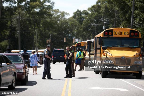 Law enforcement on the scene as students leave Heritage High School following a shooting at the school September 20, 2021 in Newport News, Virginia.