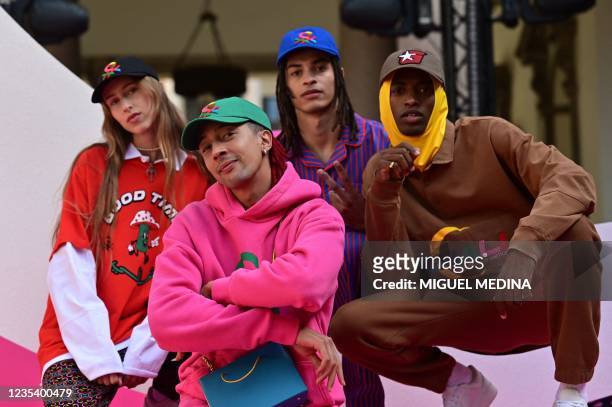 Italian rapper Ghali Amdouni, better known as Ghali, poses with models wearing his creations prior to a Benetton press conference to present United...