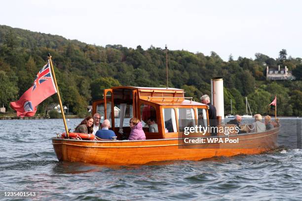 Catherine, Duchess of Cambridge speaks to Ike Alter and Diane Stoller aboard a boat on Lake Windermere during a visit on September 21, 2021 to...