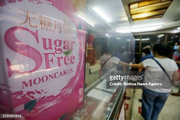 People buy mooncakes at a Chinese restaurant in Chinatown in Manila, the Philippines, Sept. 17, 2021. The Mid-Autumn Festival has become one of the...