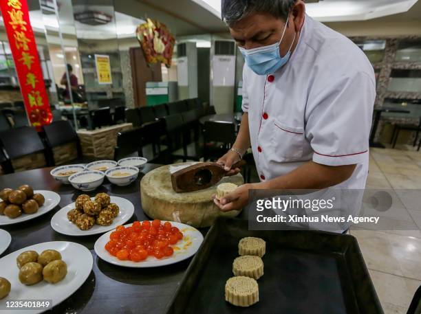 Chef makes mooncakes at a Chinese restaurant in Chinatown in Manila, the Philippines, Sept. 17, 2021. The Mid-Autumn Festival has become one of the...
