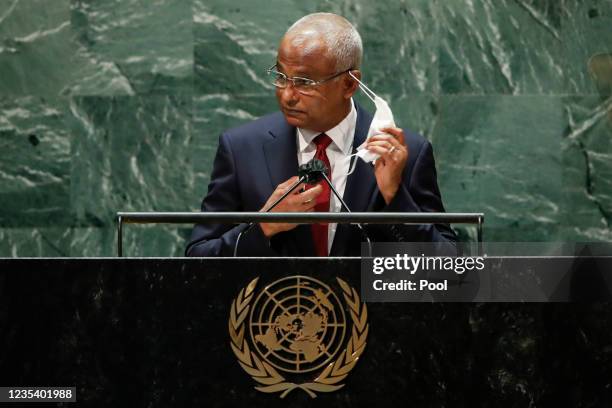 Maldives' President Ibrahim Mohamed Solih pulls off his protective face mask worn due to the coronavirus pandemic before addressing the 76th Session...