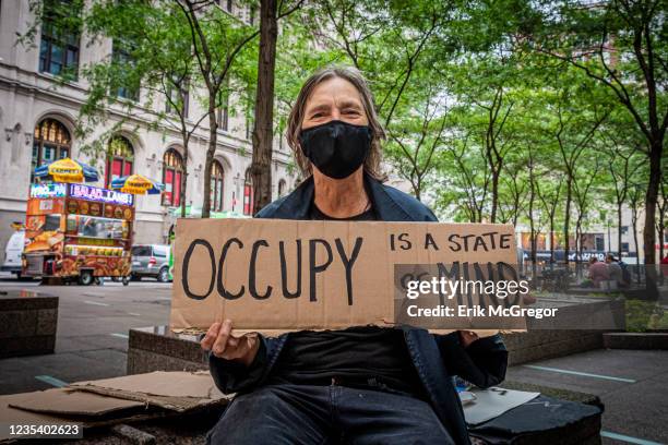 Participant seen holding a sign. Activists and elected officials stopped by Zucotti Park to celebrate the tenth anniversary of the Occupy Wall Street...