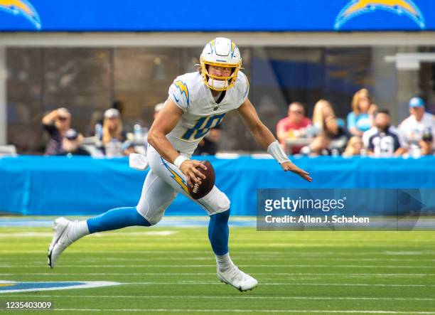 Los Angeles, CA Los Angeles Chargers quarterback Justin Herbert scrambles out of the pocket with the ball against the Dallas Cowboys at SoFi Stadium...