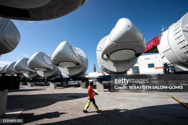 General Electric employee walks between wind turbine nacelles for the construction of a wind farm off Saint-Nazaire, in Saint-Nazaire, western...