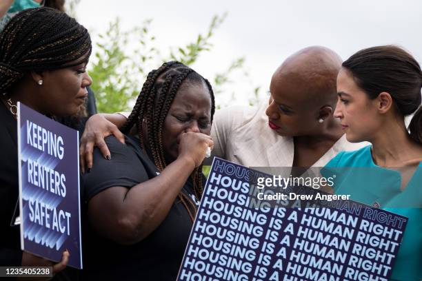 Vivian Smith, a single mother from Miami who was evicted from her home during the coronavirus pandemic, is consoled by Rep. Cori Bush , Rep. Ayanna...