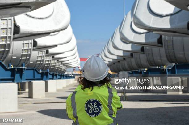 General Electric employee walks between wind turbine nacelles for the construction of a wind farm off Saint-Nazaire, in Saint-Nazaire, western...