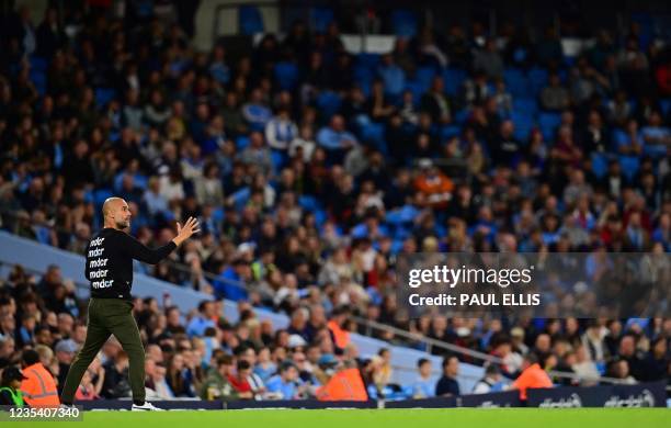 Manchester City's Spanish manager Pep Guardiola shouts instructions to his players from the touchline during the English League Cup third round...