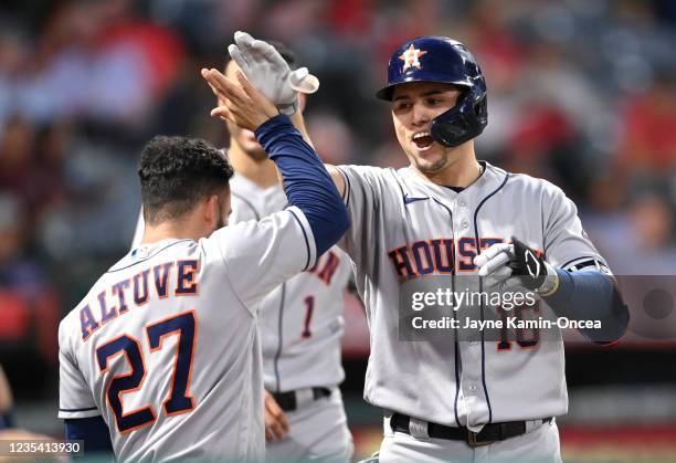 Aledmys Diaz is congratulated by Jose Altuve of the Houston Astros after hitting a solo home run in the second inning of the game against the Los...