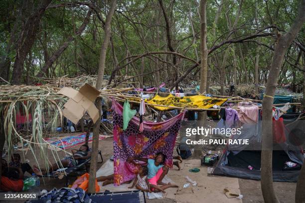 Haitian girls are pictured in a makeshift encampment where more than 12,000 people hoping to enter the United States await under the international...
