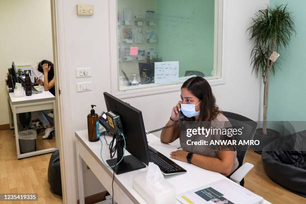 Magalie Eid, a volunteer operator, answers calls at Embrace, an NGO which runs a suicide-prevention hotline, in Lebanon's capital Beirut on September...