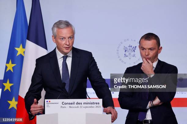French Economy and Finance Minister Bruno Le Maire , flanked by French Junior Minister of Public Action and Accounts Olivier Dussopt , delivers a...