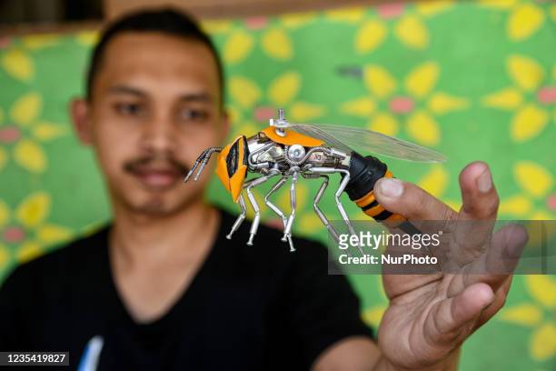 Yusuf showing Transformers bee action figures in his home in Puncak, Bogor, West Java, Indonesia on September 22, 2021. Yusuf creates art using a...