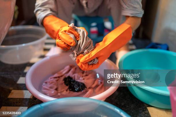 washing clothes by hands - hand washing stock pictures, royalty-free photos & images
