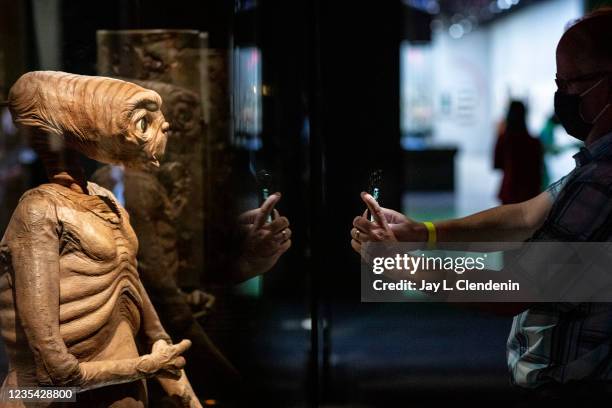 Los Angeles, CA A visitor gets a close-up of E.T. The Extra-Terrestrial, as part of the Stories of Cinema exhibit, a multi-room experience entitled...