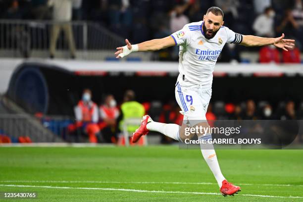 Real Madrid's French forward Karim Benzema celebrates scoring the opening goal during the Spanish League footbal match between Real Madrid CF and...