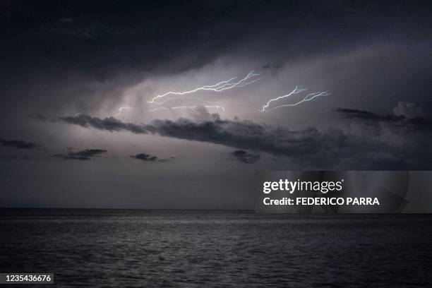 Lightnings strike over lake Maracaibo near the stilt houses of Chamitas in Catatumbo, Venezuela, on September 11, 2021. - The "Catatumbo Lightning",...