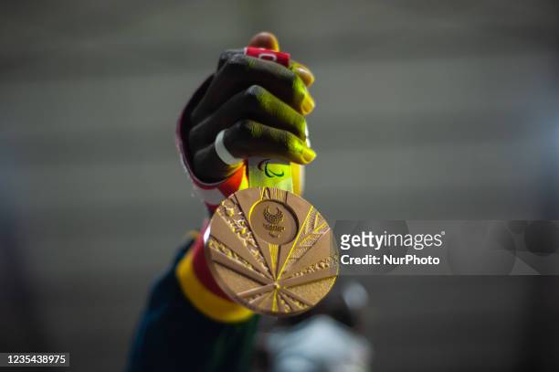 Member of Bogota's Olympic and Paralympic teams holds Fabio Torres Parapowerlifting Bronze medal during a welcoming event to Colombia's Paralympic...