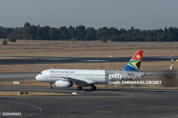 South African Airways flight is seen on the tarmac before departing from the O.R. Tambo International Airport in Johannesburg on September 23, 2021....