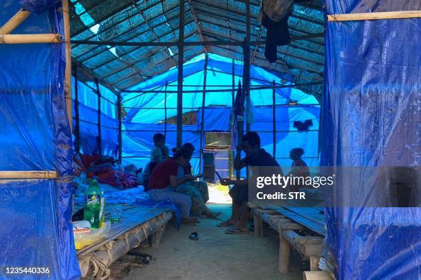 Refugees who fled Myanmar rest in a basic shelter at Farkawn quarantine camp in India's eastern state of Mizoram near the Myanmar border on September...