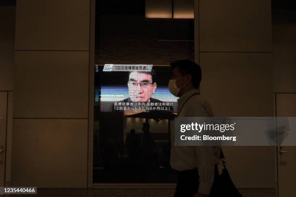Screen broadcasts news of Taro Kono, Japan's regulatory reform and vaccine minister, in Nihonbashi district of Tokyo, Japan, on Wednesday, Sept. 22,...