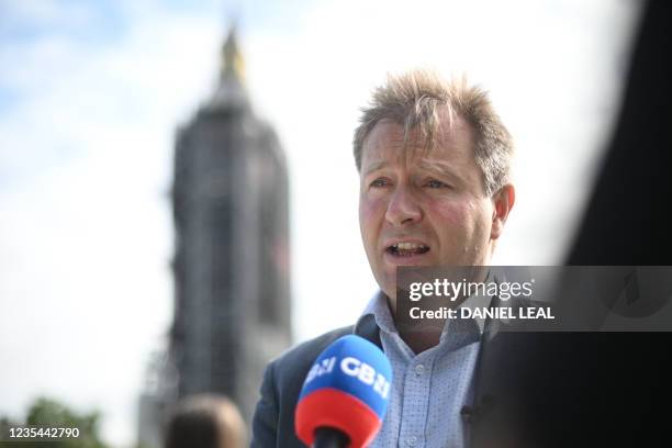 Richard Ratcliffe, husband of jailed British Iranian aid worker Nazanin Zaghari-Ratcliffe speaks to the media by a giant snakes and ladders board in...
