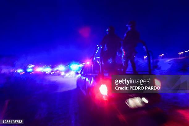 Mexican police patrol near the Rio Grande river in Ciudad Acuna, Coahuila state, Mexico, on September 23, 2021. - At least 50 police vehicles...