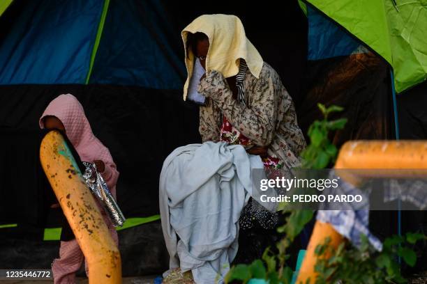 Haitian migrants are seen at a shelter in Ciudad Acuna, Coahuila state, Mexico, on September 23, 2021. - Tens of thousands of migrants, many of them...