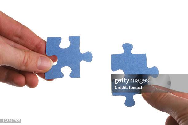 two hands coming together to solve a puzzle - connect the dots puzzle stock pictures, royalty-free photos & images