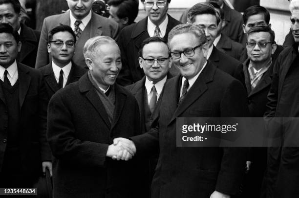 National Security Advisor Henry Kissinger shakes hand with Le Duc Tho, leader of North-vietnamess delegation, after the signing of a ceasefire...
