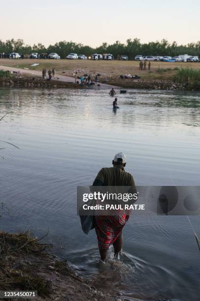 Haitian woman crosses the Rio Grande towards the US after Mexican police and National Institute of Migration officials blocked the Mexican side of...