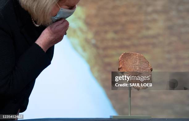 Patty Gerstenblith, a professor at DePaul University, looks at the Gilgamesh Tablet, a 3,500-year-old Mesopotamian cuneiform clay tablet that was...