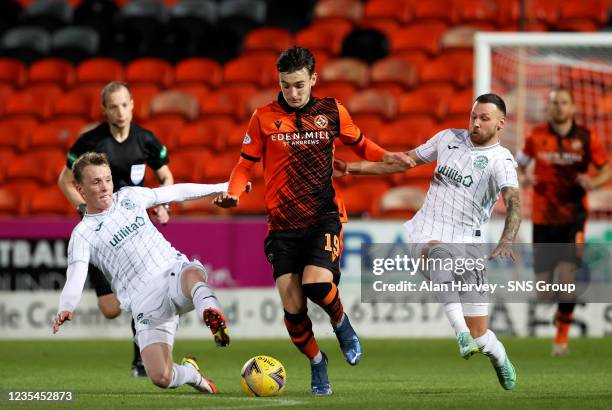 Dundee United's Dylan Levitt is tackled by Jake Doyle-Hayes and Martin Boyle during a Premier Sports Cup Quarter Final Match Between Dundee Utd and...