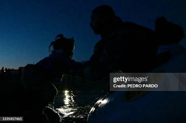 Customs and Border Protection agents on a boat rescue a young Haitian migrant from the Rio Grande river at the Mexico-US border near Ciudad Acuna,...