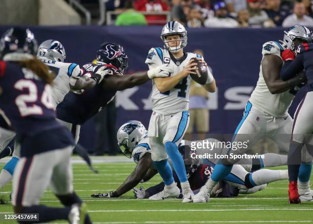 Carolina Panthers quarterback Sam Darnold evades a tackle in the third quarter during the football game between the Carolina Panthers and Houston...