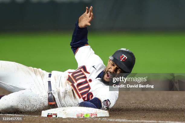 Byron Buxton of the Minnesota Twins slides into third base after a pickoff error by Thomas Hatch of the Toronto Blue Jays in the fourth inning of the...