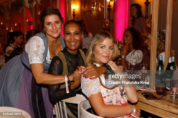 Stephanie Dettmann, Marie Amiere and Ina Aogo during the Madlwiesn 2021 at Hotel De Rome on September 23, 2021 in Berlin, Germany.