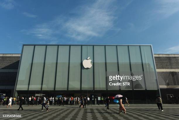 Customers queue to get newly-launched iPhone 13 mobile phones at an Apple store in Hangzhou, in China's eastern Zhejiang province on September 24,...