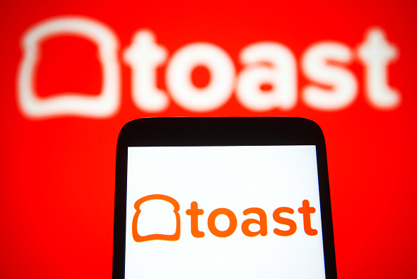 In this photo illustration a Toast Inc. logo is seen on a...