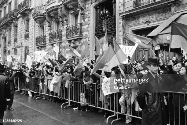 Pro-Vietcong protesters wave flags outside the conference hall on Avenue Klebber where a ceasefire agreement was signed to end the conflict in...