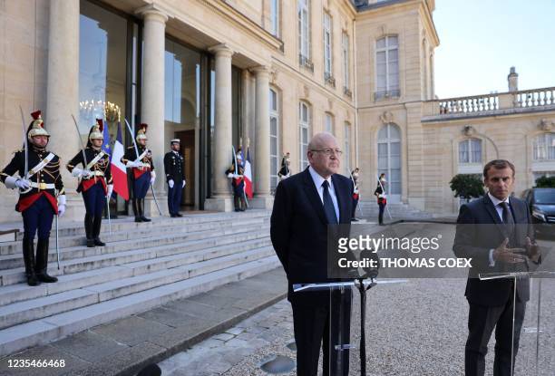 French President Emmanuel Macron and Lebanese Prime Minister Najib Mikati speak to the press after a working lunch at the Elysee Palace, in Paris, on...