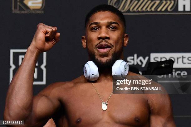 British heavyweight champion boxer Anthony Joshua gestures during his weigh-in at the O2 arena ahead of his bout with Ukraine's Oleksandr Usyk, in...